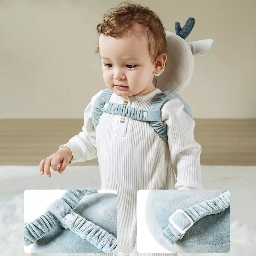 Het baby hoofdbeschermingskussen in de variant velvet rendier wordt gedragen door een jongetje. Hij staat rechtop en draagt het valkussen op zijn rug. De extra horizontale riem van het val beschermingskussen is goed zichtbaar. Dit baby valkussen biedt perfecte bescherming en heeft verstelbare riemen.